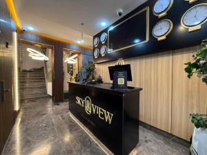 a lobby with a tv and clocks on the wall at Sky View by Luxurious Holidays in Rabat
