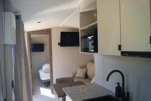 a small apartment with a kitchen and a living room at Tiny House ALPEA in Fillinges +8 photos