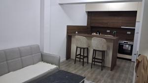 a living room with a couch and two bar stools at Cozy aparment Susanj,Bar in Bar +4 photos