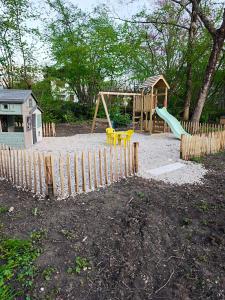 a playground with a slide and a swing set at Tiny House ALPEA in Fillinges