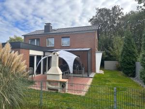 a house with a gazebo in the yard at Haus-36 in Neuss