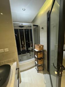 a small bathroom with a shower and a sink at Luna Villa in Al Khobar +10 photos