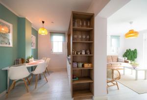 a kitchen and living room with a table and chairs at Harmony Boutique Villa in Siófok +10 photos