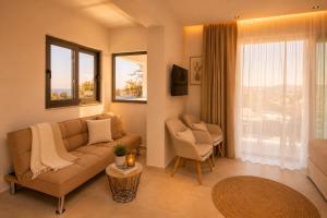 a living room with a couch and a chair at Kastri Beach Suites in Faliraki