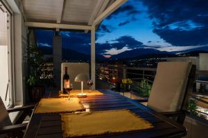 a table on a balcony with a view of the city at Gela in Livadeia