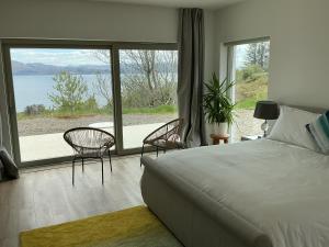 a bedroom with a bed and a view of the water at Skyelyne in Ardvasar