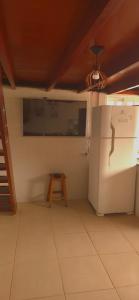 a kitchen with a refrigerator and a table in it at Bem Me Quer - Hospedagem in Trindade +31 photos