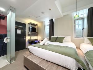 a bedroom with a large bed and a shower at A Hotel Chinatown in Singapore