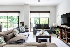 a living room with couches and a tv at Jaco Bay 1202 in Jacó