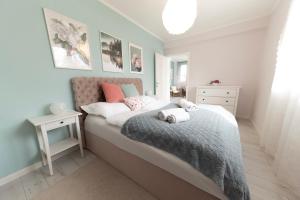 a bedroom with a bed with pillows on it at Harmony Boutique Villa in Siófok