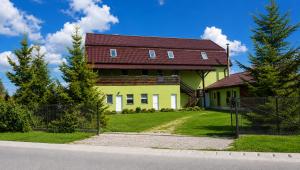 a yellow house with a red roof at Pensiunea Alpin Marisel Self Check-in in Mărişel +13 photos