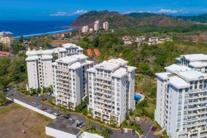 an aerial view of buildings in front of the ocean at Jaco Bay 1202 in Jacó