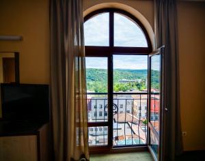 an open window with a view of a building at Hotel Premier - Veliko Tarnovo City Center, Panorama View in Veliko Tŭrnovo