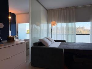 a bedroom with a black bed and a large window at Na Outra Margem - Douro River Views - Free Parking in Vila Nova de Gaia