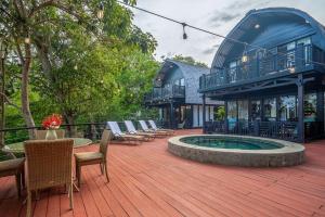 a patio with chairs and a pool in front of a building at 4 Elements - Contadora Island in Contadora
