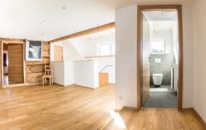 an open living room with a toilet and wooden floors at Haus No 60 Kleinwalsertal in Hirschegg +60 photos