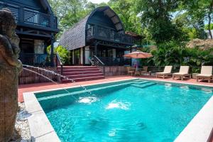 a swimming pool in front of a house at 4 Elements - Contadora Island in Contadora