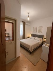 a bedroom with a bed and a window and a door at Vacation house villa roni in Durrës