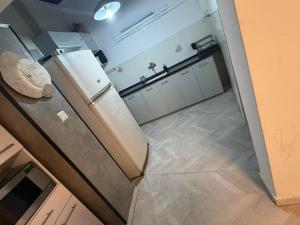 a kitchen with a refrigerator and a kitchen floor at SeaSide Villa in Ashdod
