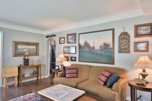 a living room with a couch and paintings on the wall at True Bed - and Breakfast! - made fresh by Grandma in Frankenmuth +24 photos