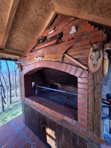 a brick fireplace in a house with at Medeni brijeg in Donji Potok