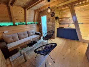 a living room with a couch and a table and chairs at Medeni brijeg in Donji Potok