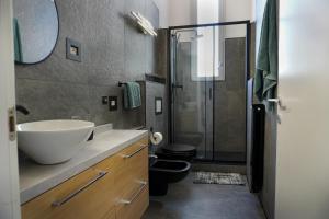 a bathroom with a sink and a shower at Malpensa Elegant Loft in Gallarate