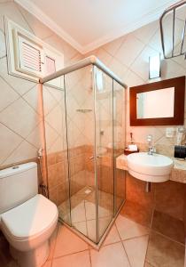 a bathroom with a toilet and a sink at Akirá Pousada in Aquiraz