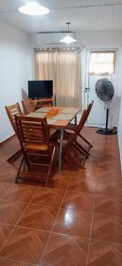 a dining room with a wooden table and chairs at Los 3 Gurises in Gualeguay