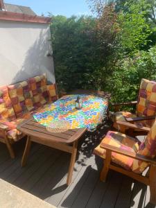a patio with a table and two chairs on a deck at Pipacs in Balatonszárszó