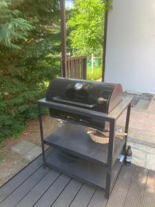 a grill sitting on a stand on a deck at Pipacs in Balatonszárszó +5 photos