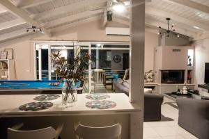 a kitchen and living room with a pool table at Gela in Livadeia