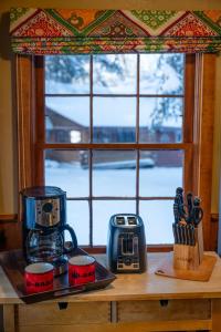 a counter with a coffee maker and a window at Riverview Cabin at O-Bar-O in Durango