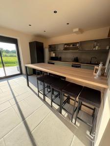 a kitchen with a long table and some chairs at gite 8 pers avec SPA MARBOZ in Marboz