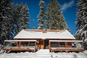 a house with snow on the roof at Riverview Cabin at O-Bar-O in Durango