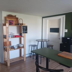 a dining room with a table and some chairs at Le nid marin in Gascons