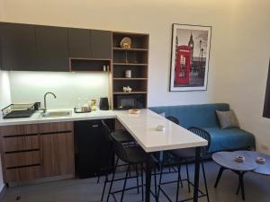 a kitchen with a sink and a table with chairs at Railway studio 3 - Luxury Suite in Byblos - Central & Relaxing in Jbeil