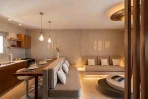 a kitchen and living room with a couch and a table at Pefki Luxury Suites in Telendos