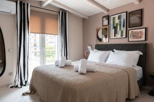 a bedroom with a large bed with towels on it at Gela in Livadeia +27 photos