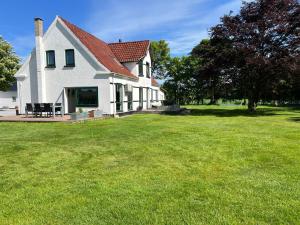 a large white house with a grass yard at Family Retreat Near Billund & Legoland 1 in Billund