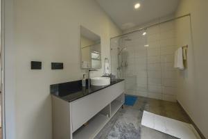 a bathroom with a sink and a mirror at Pods at Aloe Valley, Ngobit Laikipia in Gatunga +163 photos