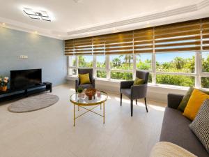 a living room with a couch and a table at MaxiHomes Hadrian in Antalya
