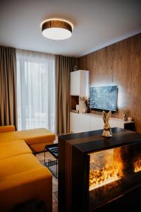 a living room with a couch and a fireplace at Apartmány Esprit in Dolný Kubín
