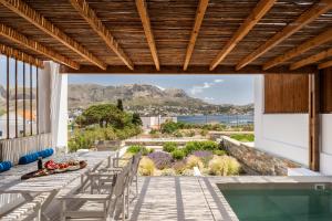 a patio with a view of the ocean and mountains at Pefki Luxury Suites in Telendos