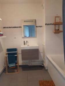a bathroom with a sink and a bath tub at Charmant studio vue dégagée à 300m de la plage in Dunkerque