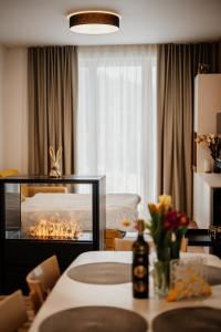 a living room with a bed and a room with a fireplace at Apartmány Esprit in Dolný Kubín