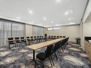 a conference room with a long table and chairs at Mercure Pakenham in Pakenham
