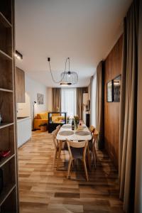 a kitchen and dining room with a table and chairs at Apartmány Esprit in Dolný Kubín