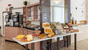 a table with bread and other food items on it at Hotel Brig in Cattolica +51 photos