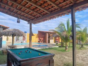 a pool table under a pergola with a pool table at Casa Cantinho do Céu Santo Amaro MA in Santo Amaro